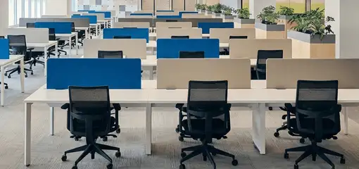 Modern open-plan office space featuring clean workstations, ergonomic chairs, and sanitized carpets provided by professional office cleaning services in Oklahoma City, OK.