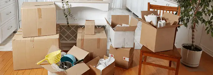 Packed moving boxes and household items in a kitchen before move-out or move-in cleaning, Oklahoma City, OK.